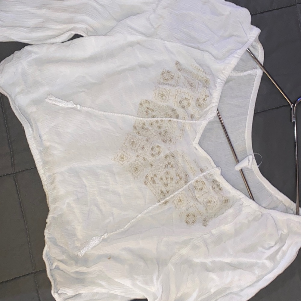 Super cute crop top. Small stain in bottom corner photograph of stain.